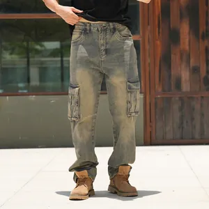 Vintage wash men's loose cargo jeans with multiple pockets on outdoor model