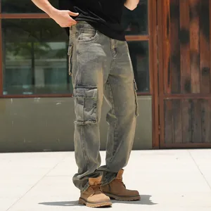 Detailed view of men's loose vintage wash cargo denim jeans with large side pockets