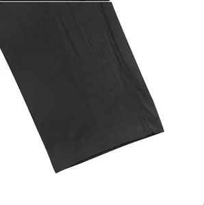 Close-up of the hem and linen fabric texture of men's loose casual black trousers