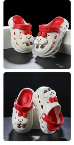 Detailed view of cute white and red cartoon clogs for kids featuring red bow character decor