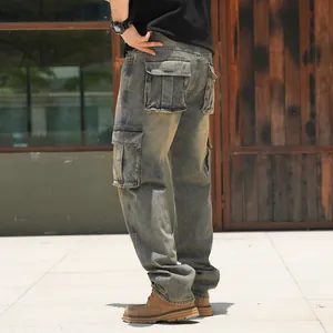 Men's loose cargo denim pants with multiple flap pockets and vintage wash finish