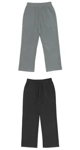 Close-up detail of loose linen pants for men in grey and black with a drawstring waist.