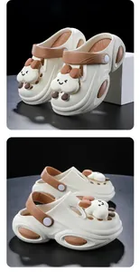 Detailed view of cream-colored women's platform clogs with cute cartoon cloud character