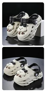 Detail view of cream and black children's cartoon clogs with a cute cloud charm