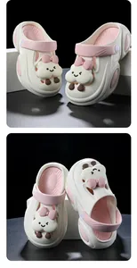 Close-up view of stylish white platform clogs with cute pink cloud charms for women