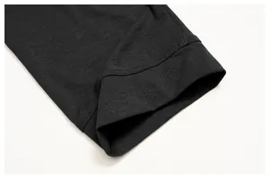 Detail of double-stitched cuff on a dark gray moisture-wicking sun protection shirt
