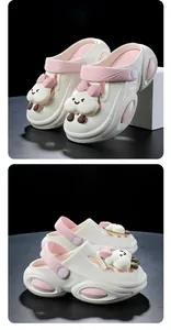 Detail view of thick-soled dopamine garden clogs with cute pink character charms