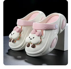 Close-up of cute cartoon cloud charm on stylish pink and white platform garden clogs