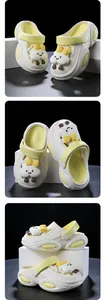 Detail view of thick-soled clog shoes with cute cartoon charms and yellow accents.