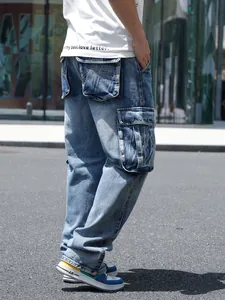 Detailed view of large side pockets on blue baggy cargo jeans for men in street style