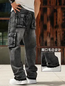 Detail of raw edge hem on men's relaxed fit dark grey washed cargo denim jeans