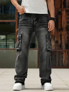 Detailed view of men's washed black multi-pocket cargo jeans with loose wide leg fit