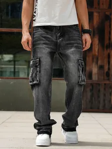 Detail view of men's loose fit cargo denim pants with multiple pockets shown on model