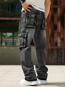 Detail view of men's loose fit black washed cargo jeans with multiple utility pockets.