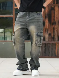 Detailed view of men's vintage washed cargo jeans with wide leg and multi-pockets.