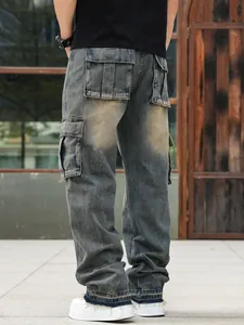 Detail of men's baggy cargo jeans showing multiple pockets and vintage wash finish