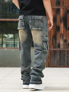 Back detail of men's loose fit multi-pocket cargo denim jeans in vintage washed blue