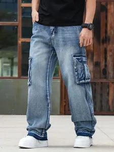 Detail view of men's loose-fit multi-pocket cargo jeans in premium washed blue denim