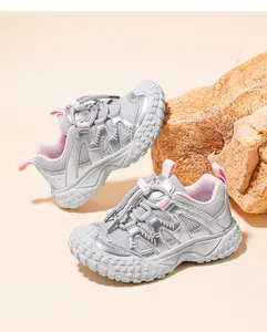 Detailed view of silver kids sneakers with pink lining and breathable mesh upper