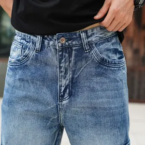 Close-up detail of blue washed denim cargo jeans featuring high waist and pockets