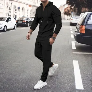 Full view of men's black waffle knit casual tracksuit with hoodie and matching pants.