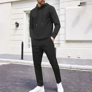 Stylish men's black waffle knit hoodie and long pants set for outdoor casual activities
