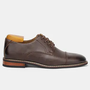 Side view of classic brown men's business leather dress shoes with wooden shoe tree insert