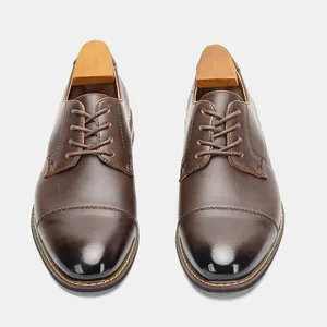 Top-down view of classic brown leather dress shoes with professional wooden shoe trees