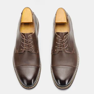 Top-down view of classic brown men's leather cap toe business dress shoes with laces