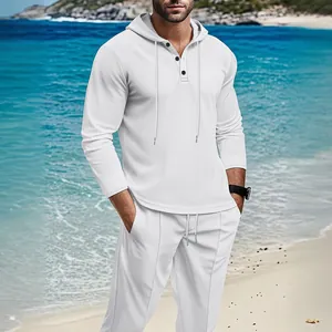 Close-up view of the white waffle knit fabric on a men's outdoor hoodie and pants set