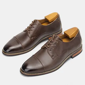 Detailed view of classic brown leather men's business shoes with wood shoe trees