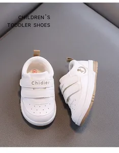 Close-up of breathable white toddler walking shoes with velcro straps and brown sole