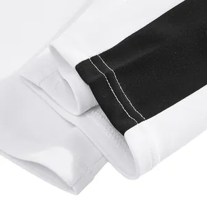 Close-up of white sports sweatpants cuff with black stripe and double stitching