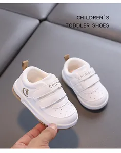 Detail view of breathable white leather toddler walking shoes with double velcro straps
