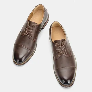 Detailed top-down view of brown men's dress shoes with classic cap toe and laces