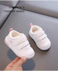 Macro detail of white and pink toddler walking shoes with secure velcro straps