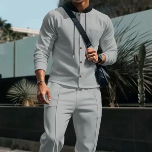 Detail of men's grey waffle knit hooded cardigan and matching casual trousers set