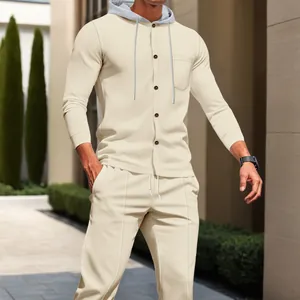 Full detail of beige waffle knit hooded cardigan and matching trousers on male model.