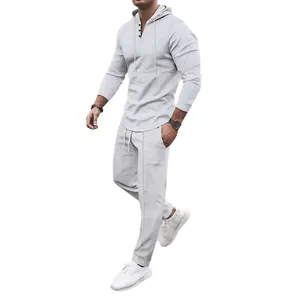 Men's waffle knit two-piece tracksuit set with hooded long-sleeve top and matching joggers.