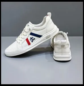 Detail view of white leather men's sneakers with blue and red stripe accents