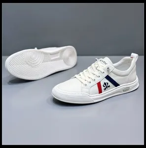 Close-up of stylish white men's leather casual sneakers with red and blue stripes