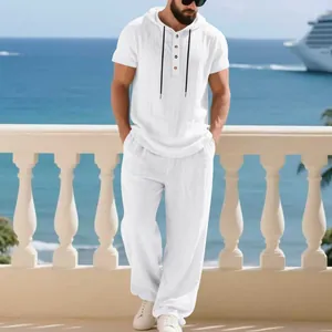 Full view of men's white linen resort set with hooded Henley shirt and loose pants