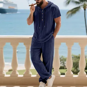 Detailed view of men's navy linen hooded Henley shirt and pants leisure outfit