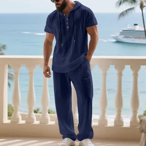 Detail view of navy blue men's linen hooded Henley shirt and pants set on balcony