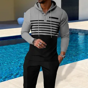Detailed texture view of men's gray and black waffle knit hoodie and pants set by pool