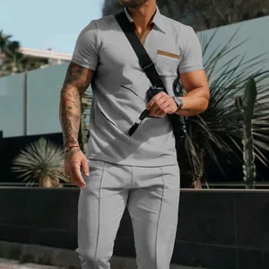 Casual men's summer set featuring a grey waffle knit polo shirt and matching trousers