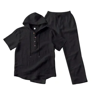 Detailed view of men's black linen-textured hooded shirt and matching trousers