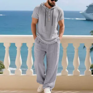 Casual men's grey linen hooded Henley shirt and pants set for seaside vacation