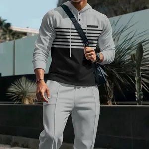 Close-up of men's waffle knit hooded tracksuit with grey and black striped design