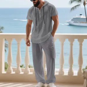 Men's grey relaxed linen hooded Henley shirt and matching long pants set for summer travel